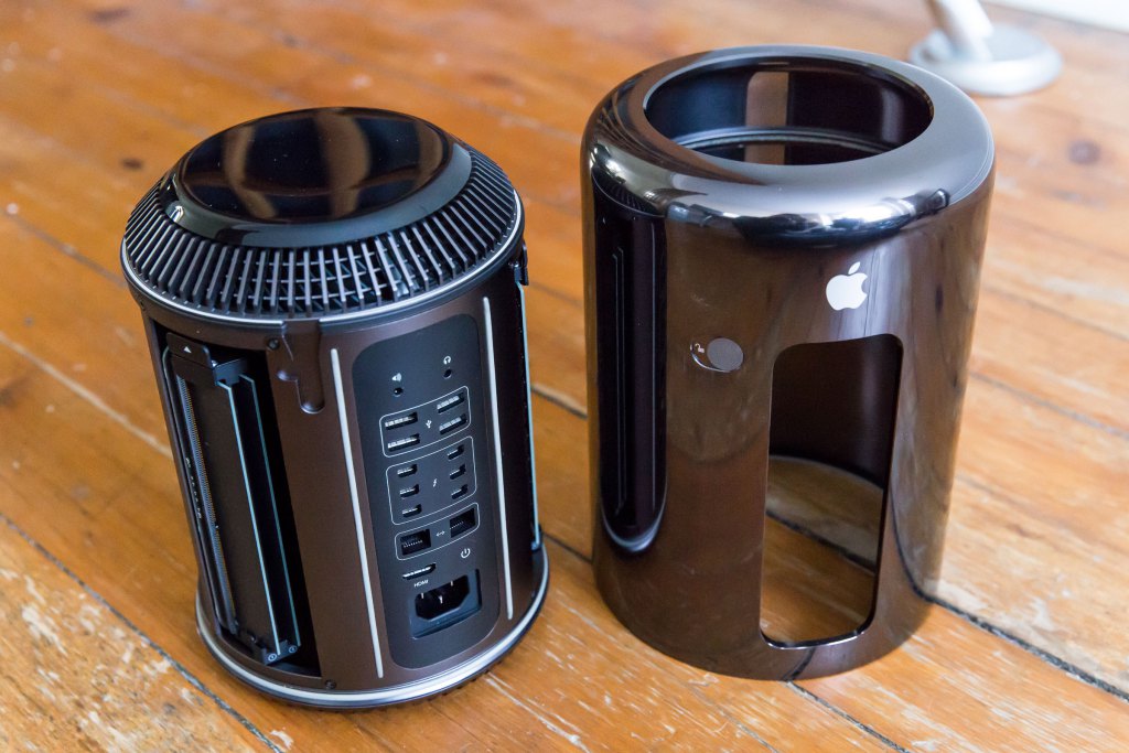 The new Mac Pro with its case removed, side by side with said case.